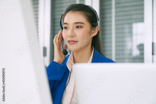 Asian female call center test headset before start working in a day