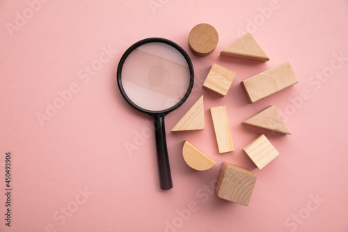 Magnifying glass with a selection of different shaped wooden blocks