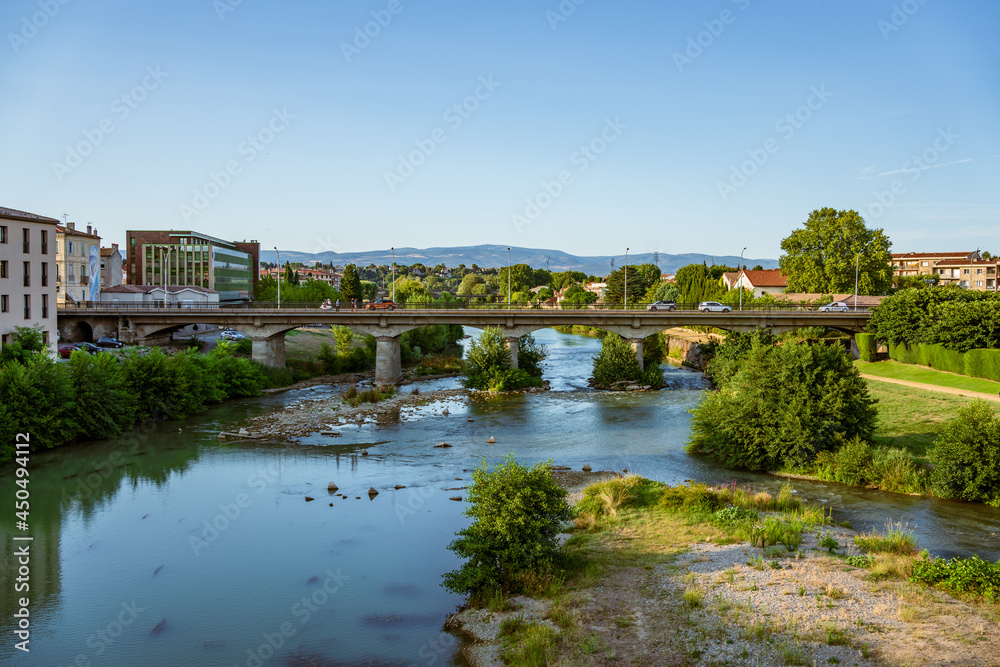 Carcassonne, France. View of river Aude and a modern bridge with cars and pedestrians.