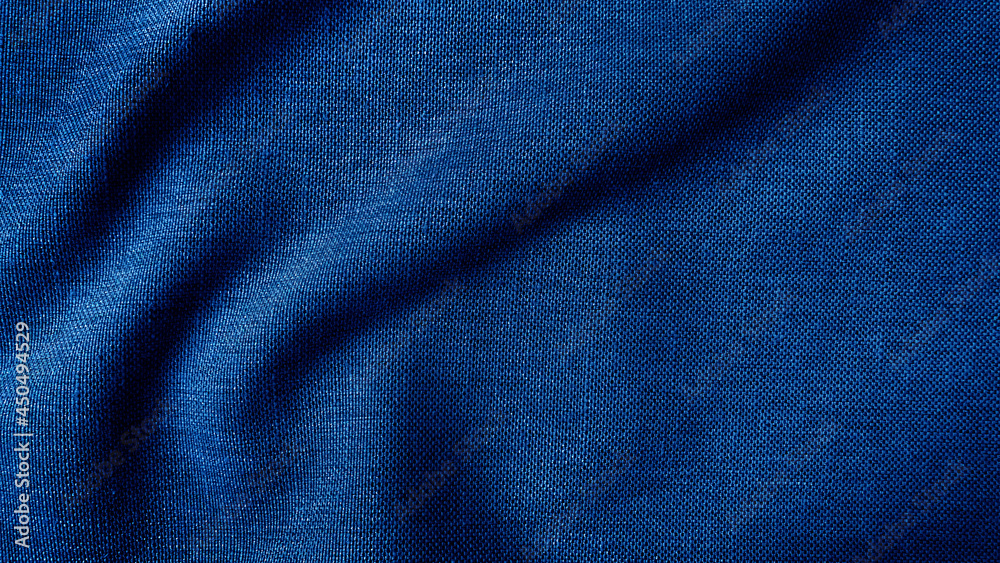 close up texture of creased fabric. blue woolen fabric. blue wavy cloth background showing fiber detail. blue fabric background with beautiful light and shadow. close up texture of creased fabric. blue woolen fabric. blue wavy cloth background showing fiber detail. blue fabric background with beautiful light and shadow.