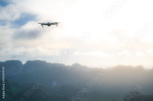 Flying drone above the view of mountains and hills. Concept drone taking photo during travel