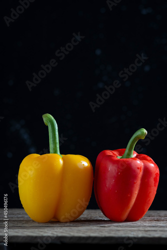 red and yellow peppers for salad  on a wooden table  in a rustic style. minimalistic concept