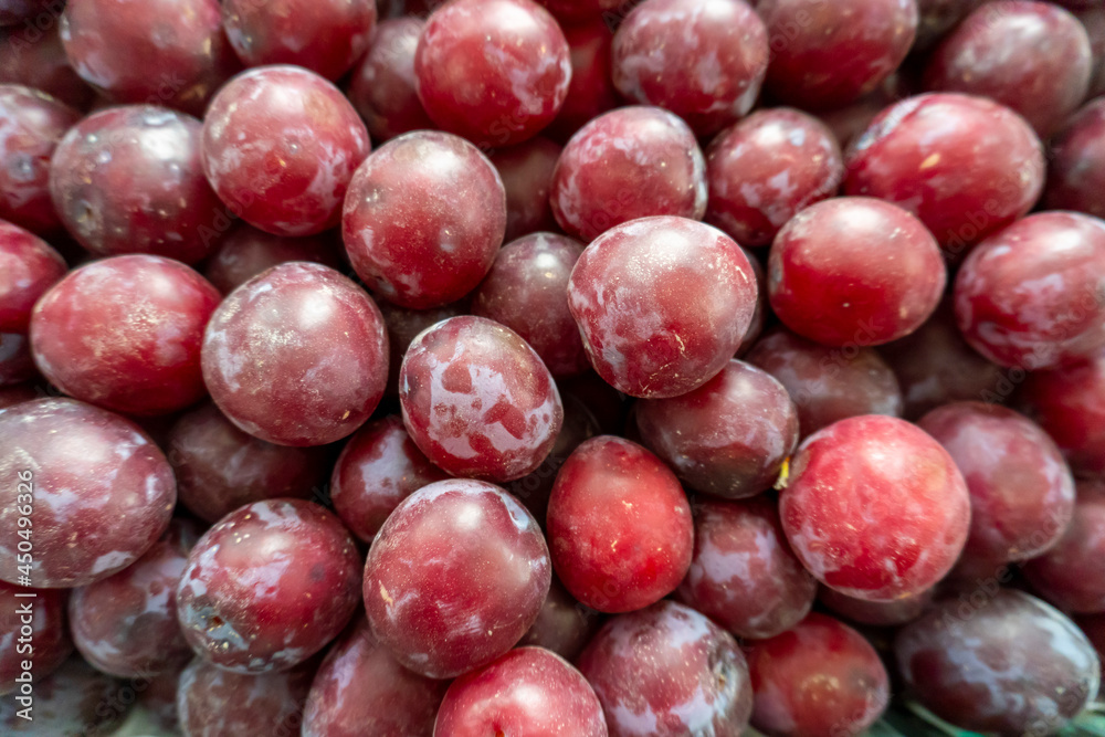 photo of a lot of plums on the counter of the store photo of a lot of plums on the counter of the store