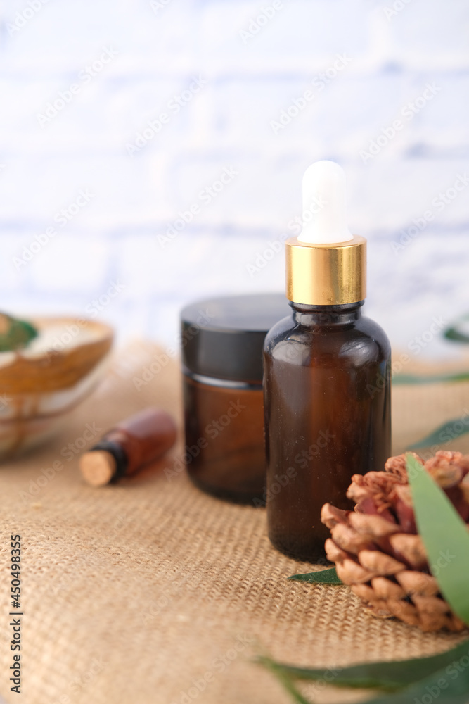 eucalyptus essential oils in a glass bottle with green leaf on white background eucalyptus essential oils in a glass bottle with green leaf on white background