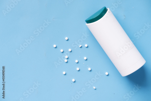 artificial sweetener container on blue background 
