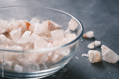 close up of pink rock salt in a bowl on table 