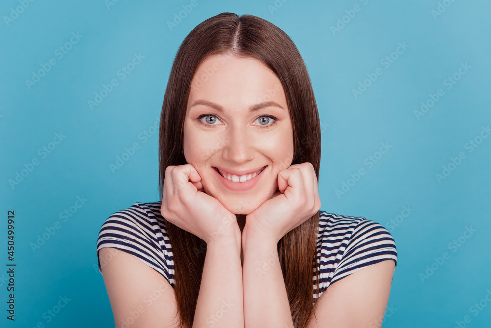 Portrait of pretty stunning sweet lady hands cheeks beaming smile on blue background Portrait of pretty stunning sweet lady hands cheeks beaming smile on blue background