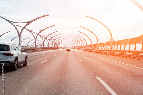 Car driving on highway road. Cars crossing bridge interchange overpass. Highway interchange with traffic. Road junction. Bridge with traffic