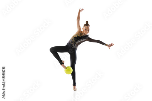 Portrait of little girl, rhythmic gymnastics artist isolated on white studio background. Concept of sport, action, aspiration, education, active lifestyle