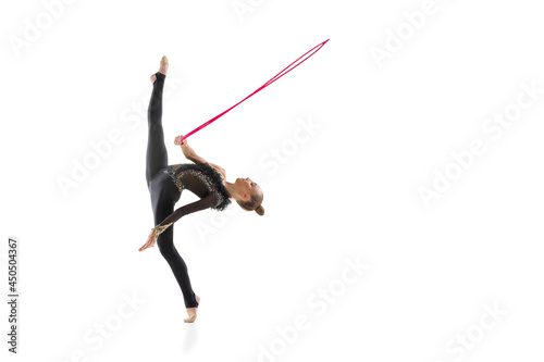 One Caucasian girl, rhythmic gymnastics artist isolated on white studio background. Concept of sport, action, aspiration, education, active lifestyle