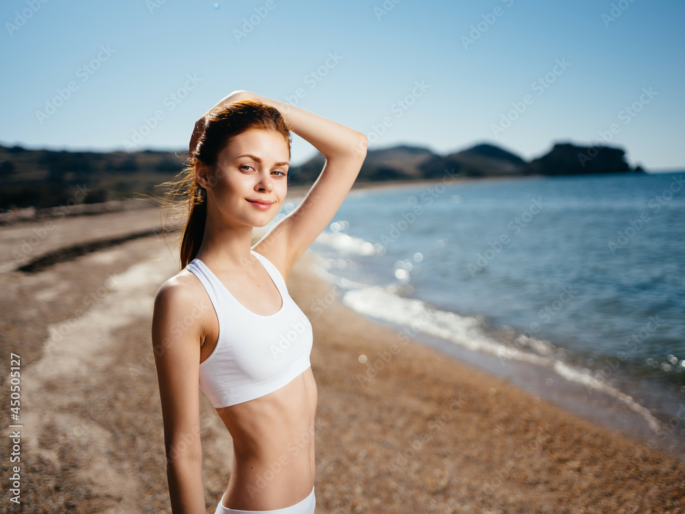 Woman in white swimsuit on the beach ocean summer Woman in white swimsuit on the beach ocean summer