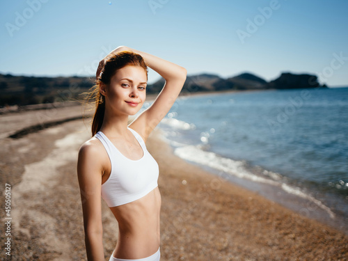 Woman in white swimsuit on the beach ocean summer
