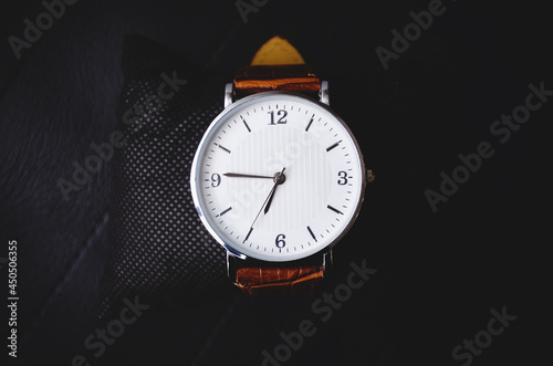 Men's classic watches on a black background. Stock photo, top view.