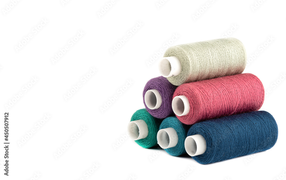 Pyramid from spools of threads of different colors on a white background. Pyramid from spools of threads of different colors on a white background.