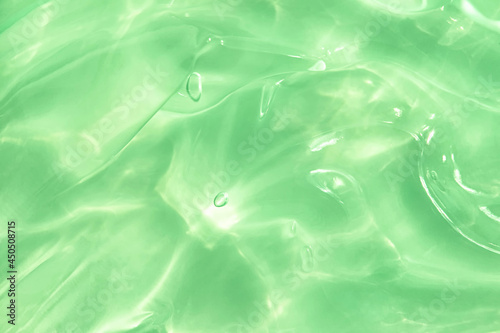 Green water Aloe Vera gel smudged texture. Abstract clear cosmetic cream, face serum, moisturizer background