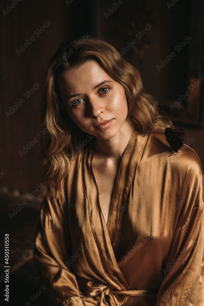 Fototapeta premium Young attractive female sitting with butterfly on her shoulder