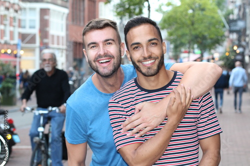 Two cute guys showing affection outdoors