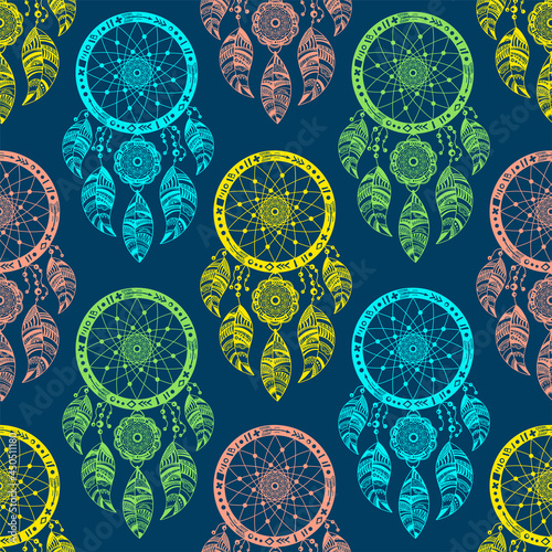 Dream catchers with bird feathers, colorful vector illustration on blue background. Ethnic Indian amulet in the boho style. Seamless pattern for printing on fabric and wrapping paper
