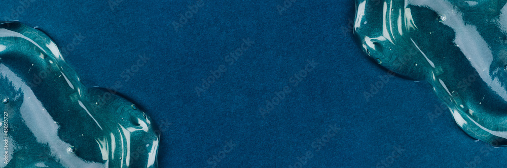 Transparent hyaluronic acid gel on a blue background. Transparent hyaluronic acid gel on a blue background.
