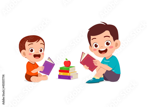 cute little boy read book with baby brother sibling together