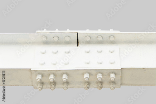  Large screw hexagon flange nut Supporting structures, metal frame of prefabricated building. large metal posts or structure are painted in white of outdoor billboard. Isolated on grey background.