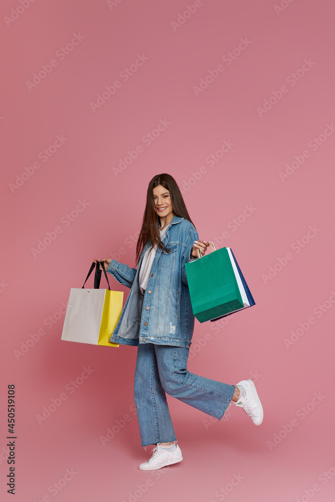 beautiful woman holding shopping bags with purchases