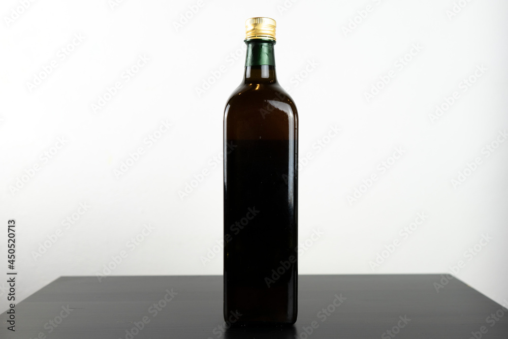 Dark olive oil bottle without label for mockup purposes Dark olive oil bottle without label for mockup purposes