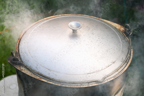 A cauldron covered with a lid on a Asian oven