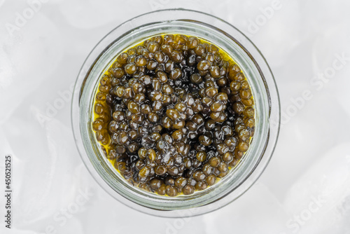 Obraz na płótnie Caviar black in glass jar in ice cube w salonie