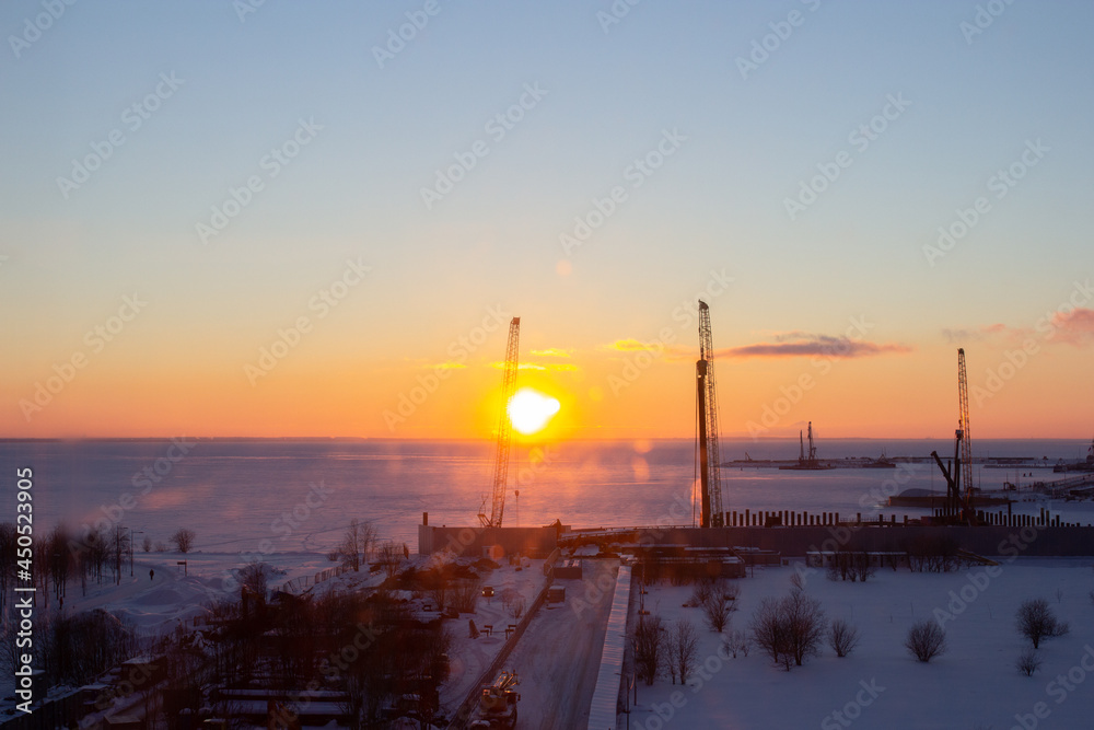 Skyline with sunset, construction and Russian winter
