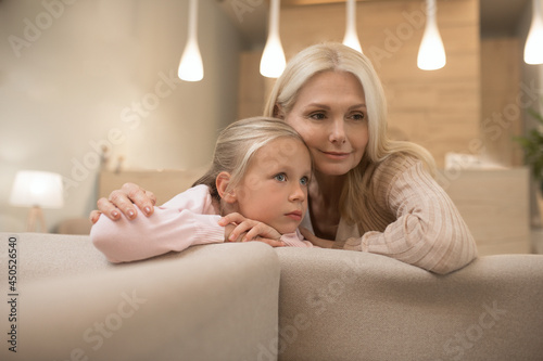 A blonde woman and her daughter waiting for the appointment at the clinic photo