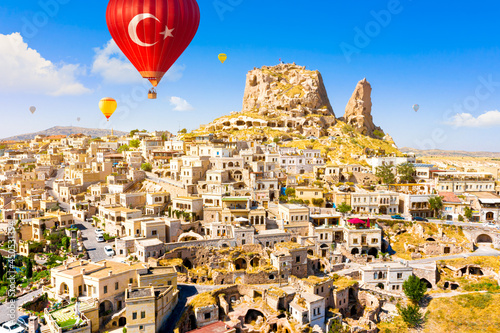 Hot air balloons flying over Uchisar Castle. Cappadocia. Nevsehir Province. Turkey photo