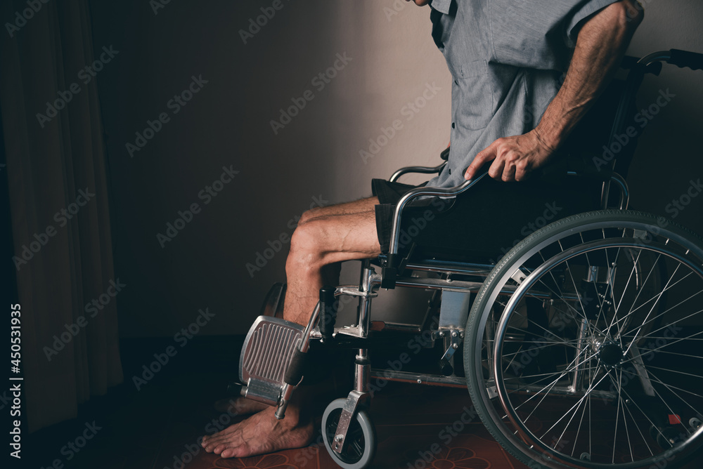 Obraz premium Lonely disabled man on wheelchair in the house, Depression occurs in people with disabilities who are alone at home...
