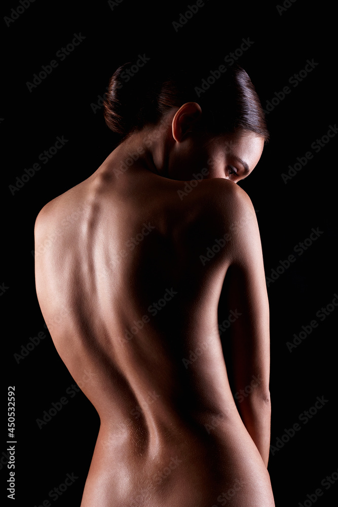 Female silhouette. Naked Woman. Sensual Girl in dark. Beautiful Back