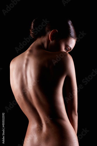 Female silhouette. Naked Woman. Sensual Girl in dark. Beautiful Back