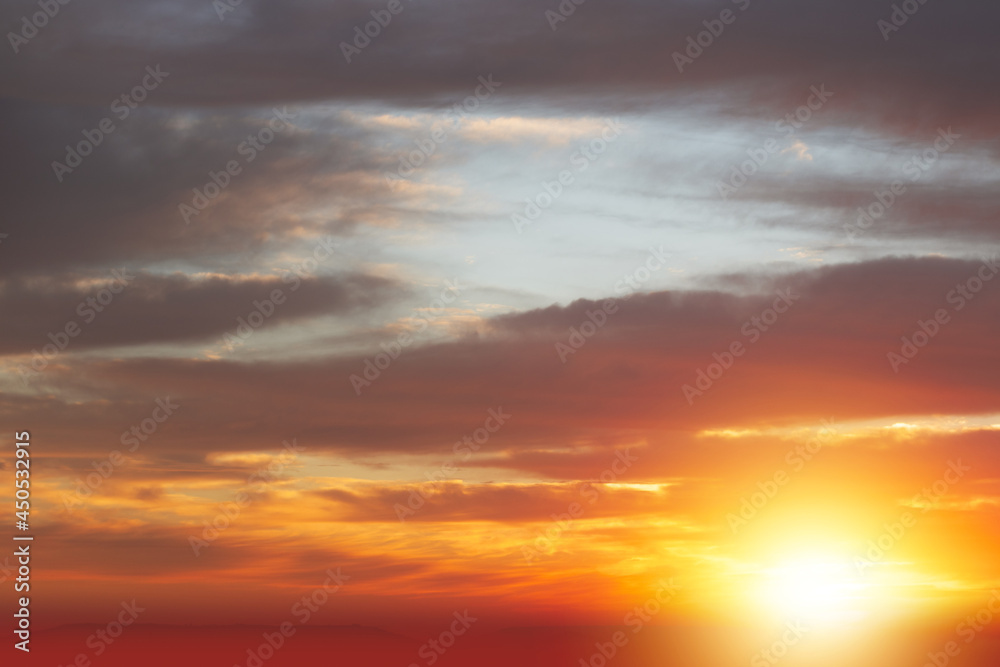 Sunrise sky with red color fire on a cloudy winter day. Space for text.