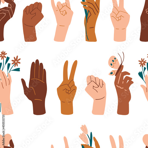 Palms seamless pattern. Different skin colors hands with flowers