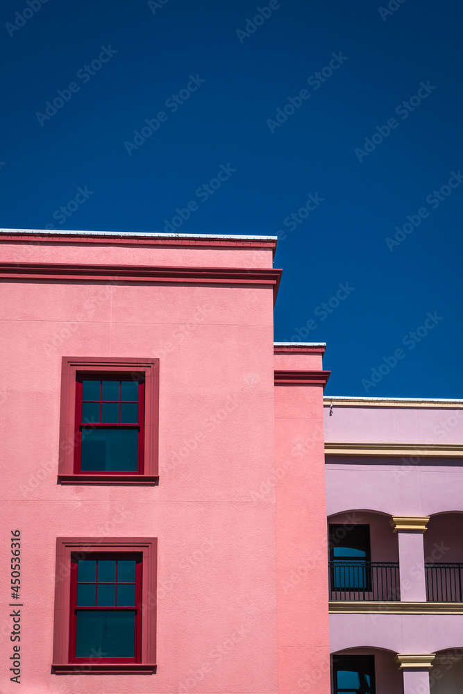 Colorful building facades against deep, bright blue sky