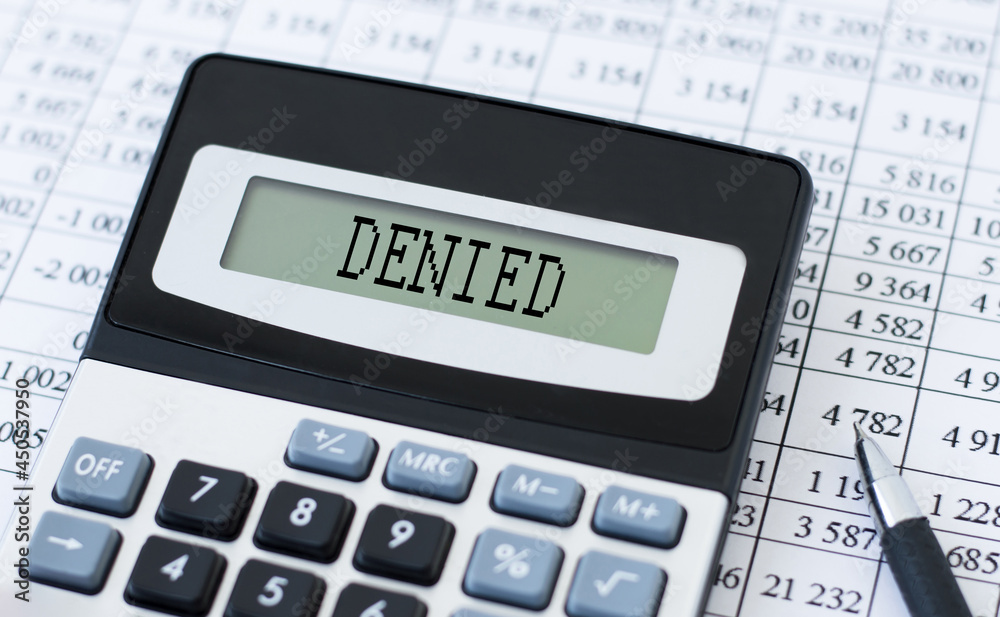 Calculator with text claim denied on table, business concept Calculator with text claim denied on table, business concept