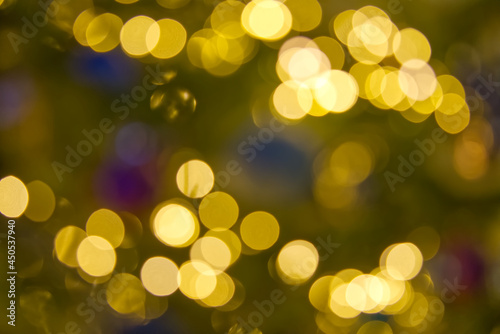 blurred christmas lights abstract background on dark backdrop. Yellow Circular reflections of Christmas lights.