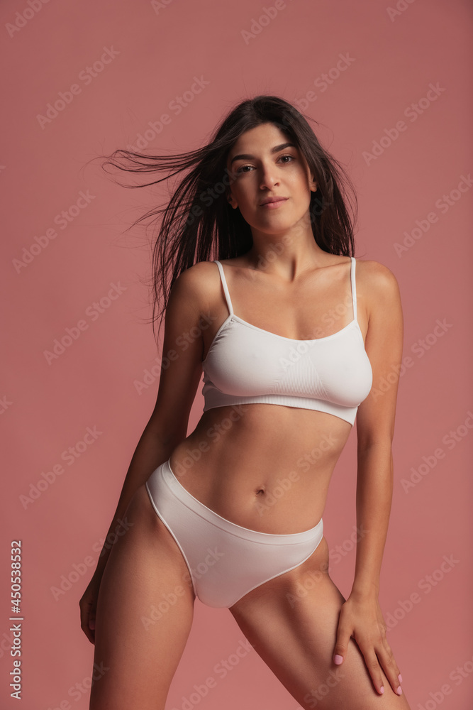 © master1305 - Close-up portrait of young beautiful arabian woman without makeup isolated over pink studio background. Natural beauty concept.