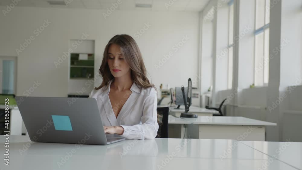 Slow motion of a young worker who sits on laptop Slow motion of a young worker who sits on laptop