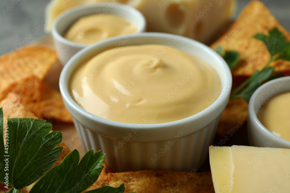 Concept of snack with chips and cheese sauce, close up Concept of snack with chips and cheese sauce, close up