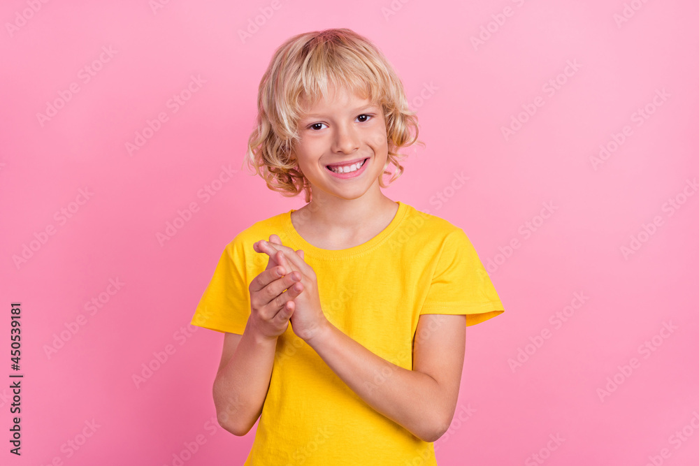 Photo of young boy happy positive smile applauding victory success content isolated over pink color background Photo of young boy happy positive smile applauding victory success content isolated over pink color background