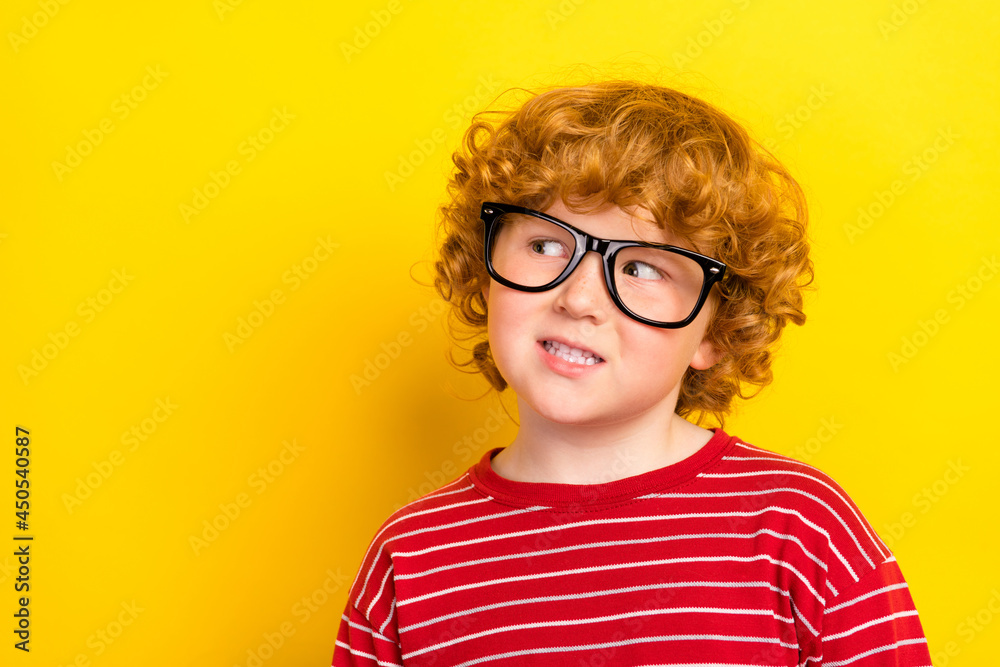 Photo of young dreamy happy charming boy look empty space wear glasses isolated on yellow color background