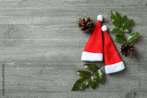 Santa hats and Christmas accessories on gray textured background