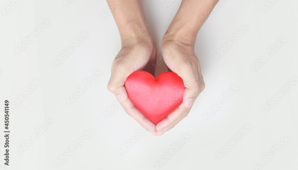 Hands holding red heart. heart health donation concepts Hands holding red heart. heart health donation concepts