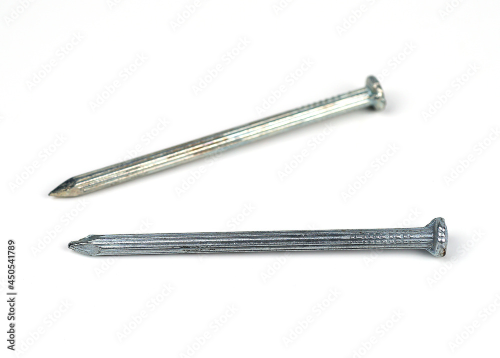 Two silver concrete nails on a white background.	