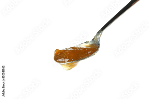 Spoon with peach jam isolated on white