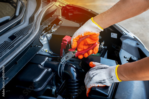 The mechanic uses pliers to check the condition of the car and fix the car.